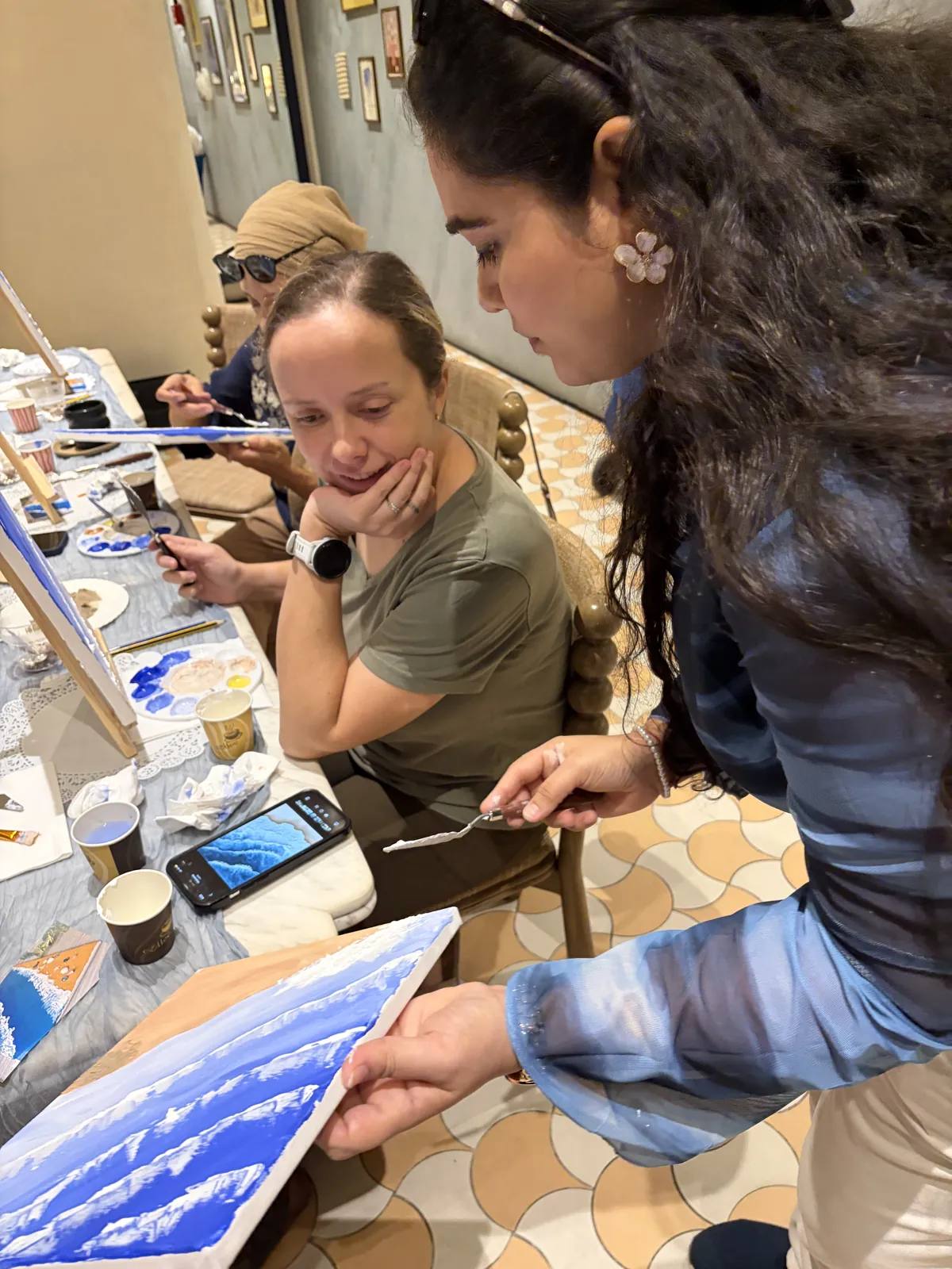 Guests painting at an Art & Pause workshop