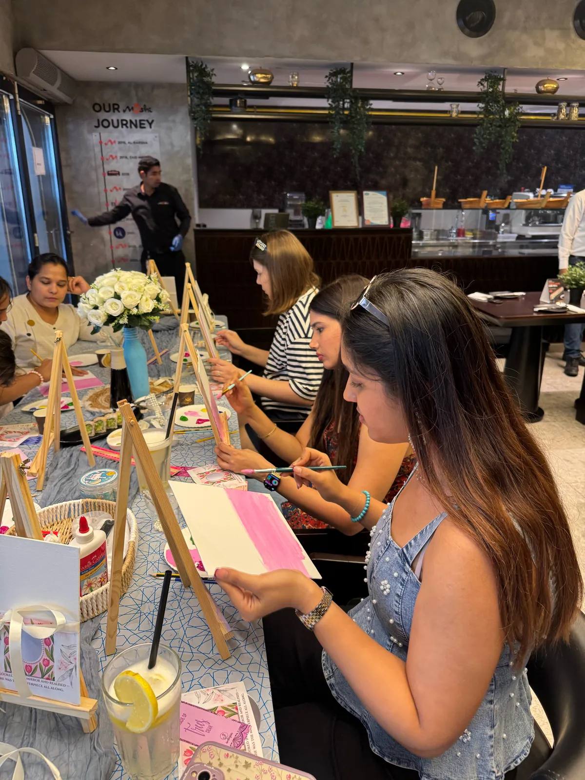 Guests painting at an Art & Pause workshop