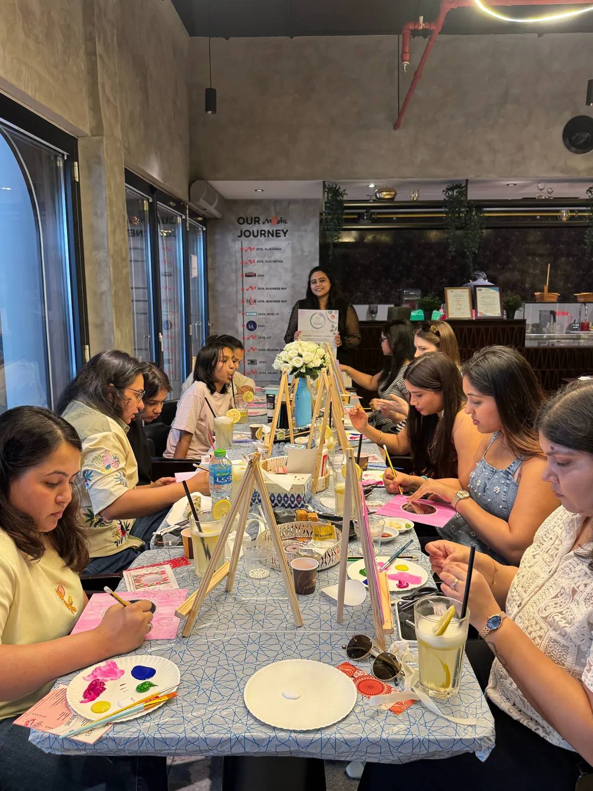Guests painting at an Art & Pause workshop