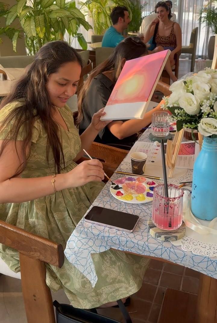 Guests painting at an Art & Pause workshop in a café