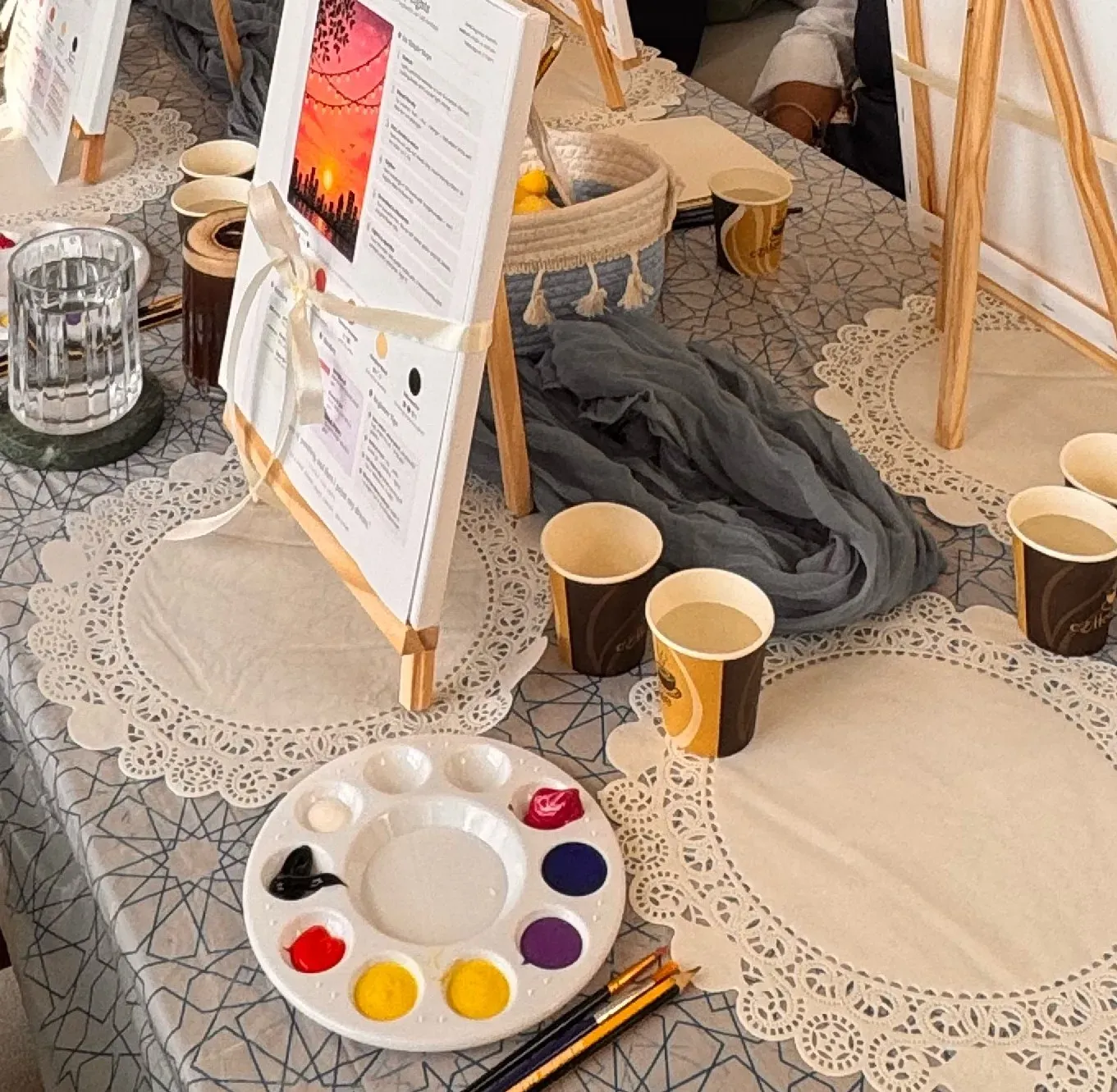 Sunset reference card on a small easel with a palette of red, yellow, purple, blue and black